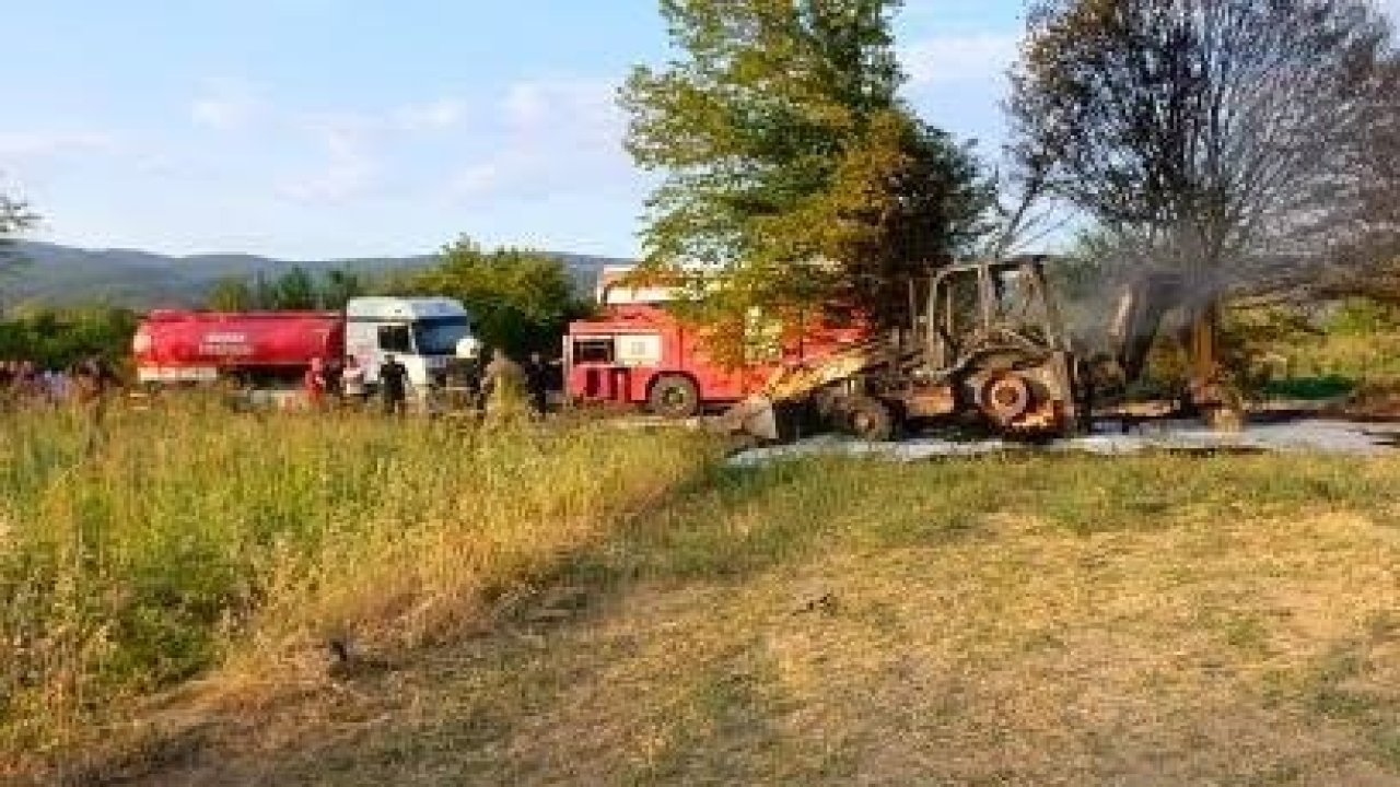 Tarlada ağaç sökümü yapan iş makinesi alev alev yandı