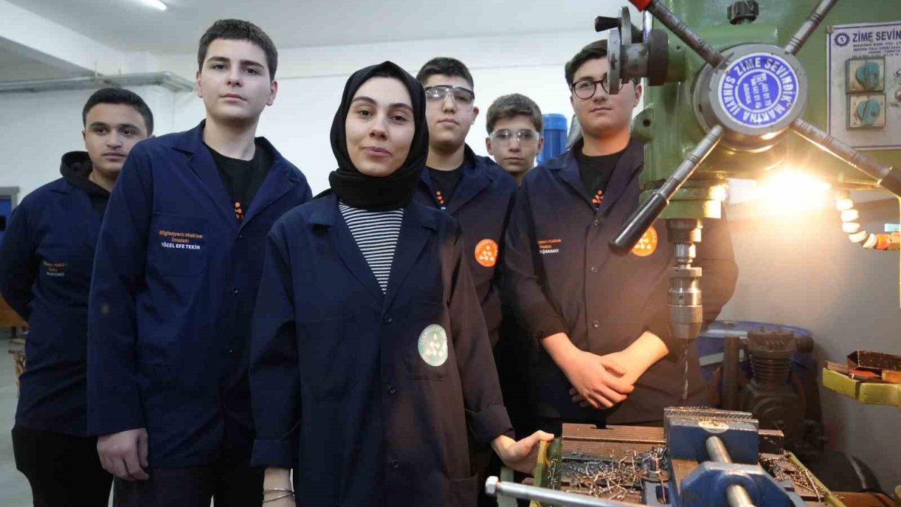 Kadın öğretmen torna tezgahında öğrencilerine üretimi öğretiyor