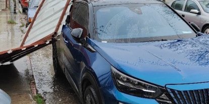 Fırtınanın etkisiyle yapıdan kopan parça araca zarar verdi