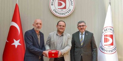 BŞEÜ’ye gümüş madalya ve madalya beratı takdimi